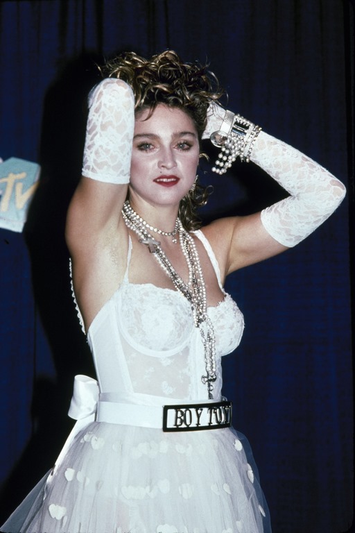 American singer and actress Madonna, dressed in white lace lingerie, pearls, and a 'Boy Toy' belt buckle, stands with her arms on her head at First Annual MTV Video Music Awards, held at Tavern on the Green, New York, New York, September 14, 1984. (Photo by David Mcgough/DMI/The LIFE Picture Collection/Getty Images)