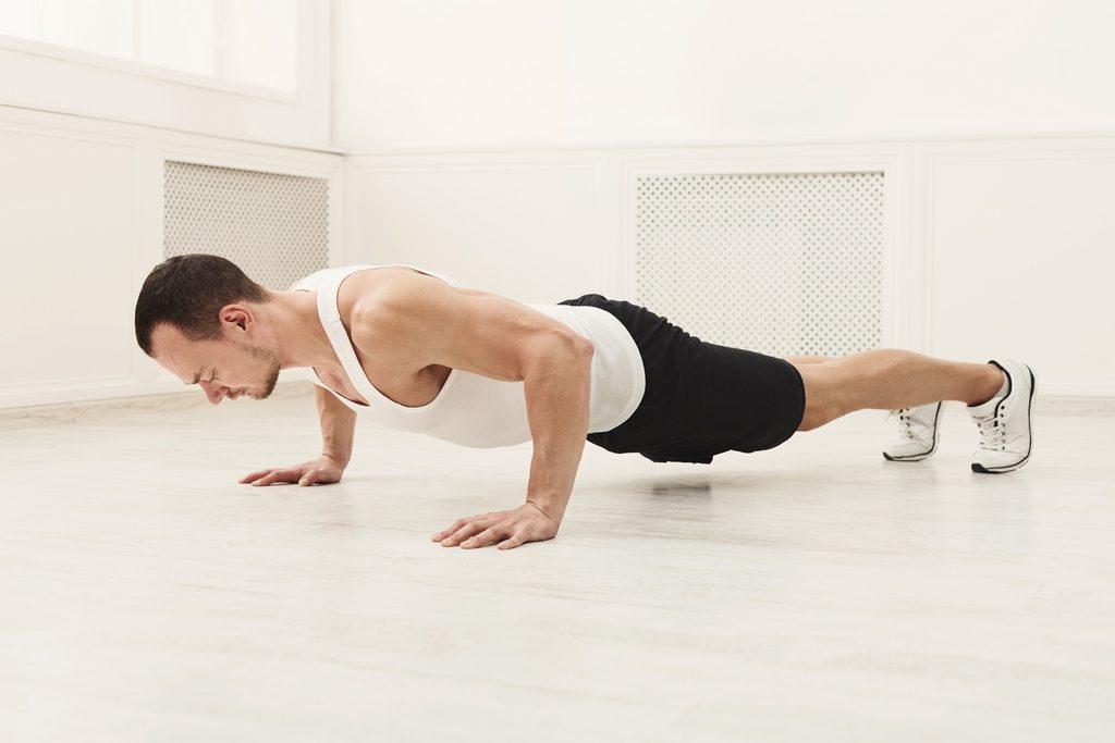 Male sportsman doing plank